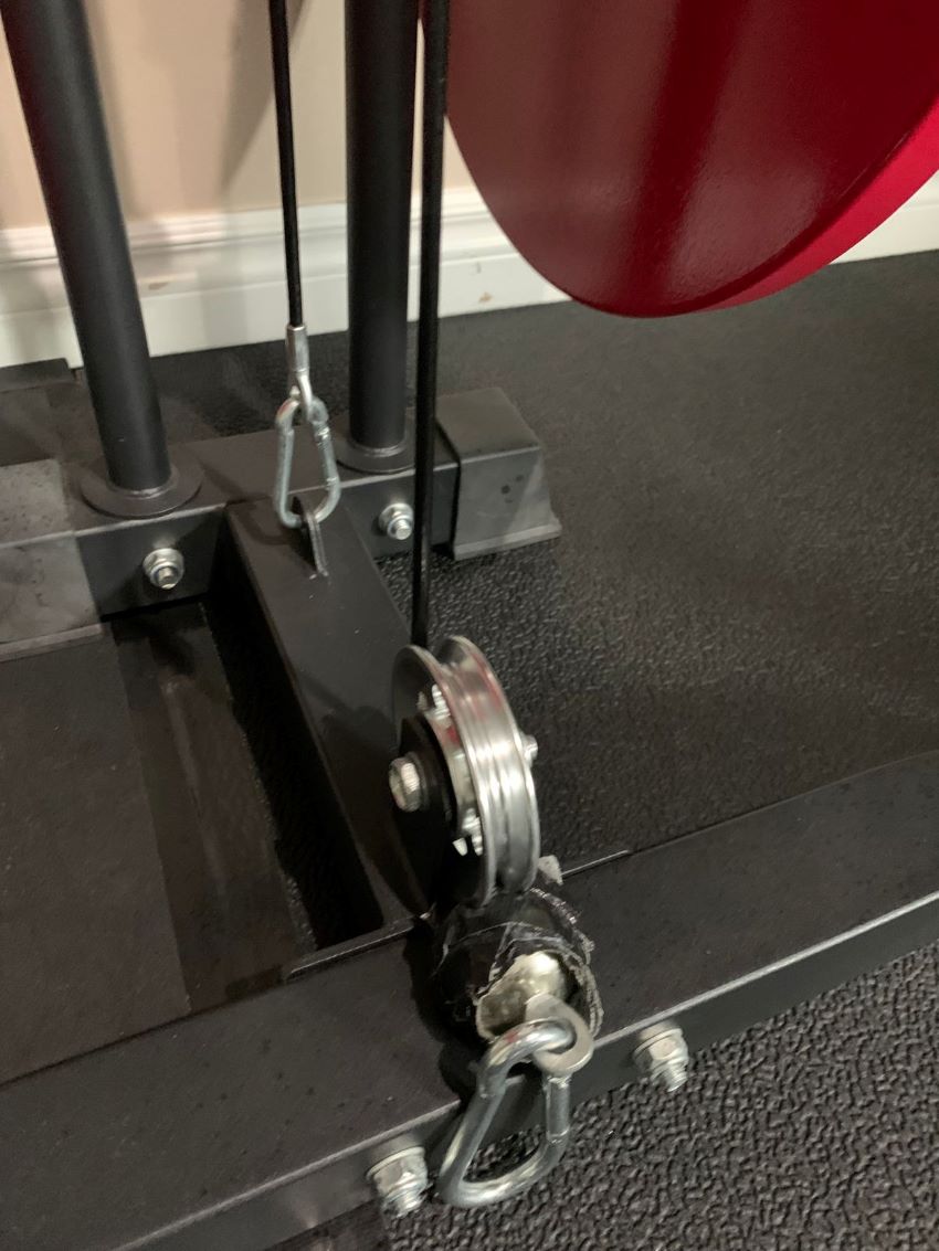 Stainless steel pulley wheel installed on a clothesline for smooth operation.
